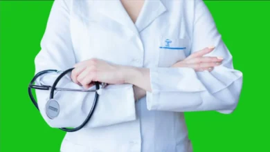 A female doctor wearing a white coat and holding a stethoscope